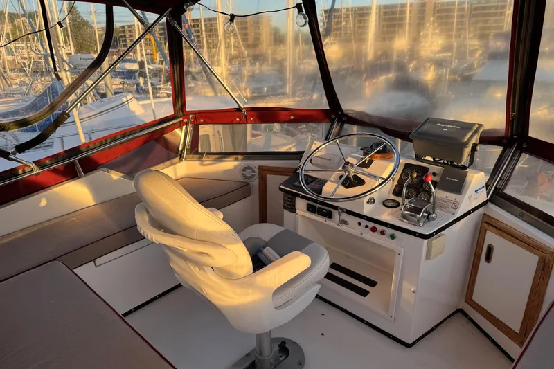 Slide: The Image of Cockpit of a 1987 President 37 yacht with steering wheel and navigation equipment. - 63
