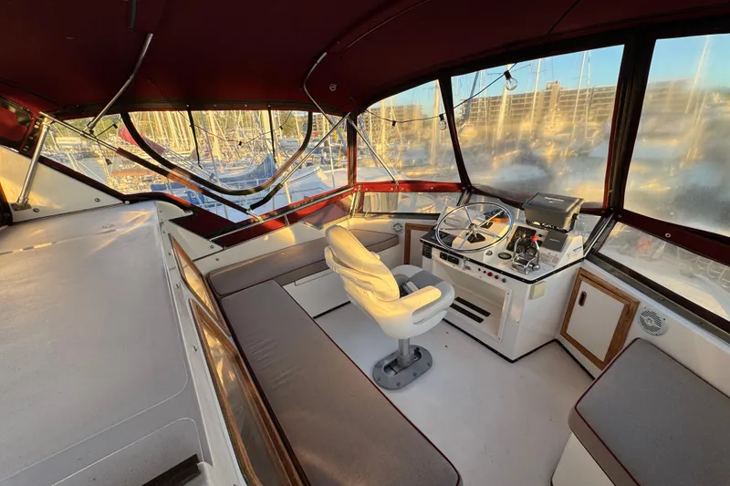Slide: The Image of Interior of a 1987 President 37 yacht with helm and seating area. - 64