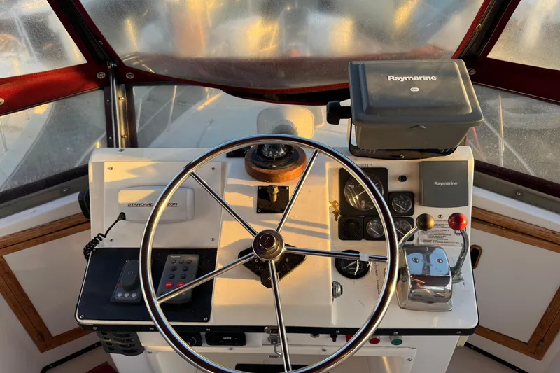 Slide: The Image of Helm of a 1987 President 37 boat with steering wheel and navigation equipment. - 65