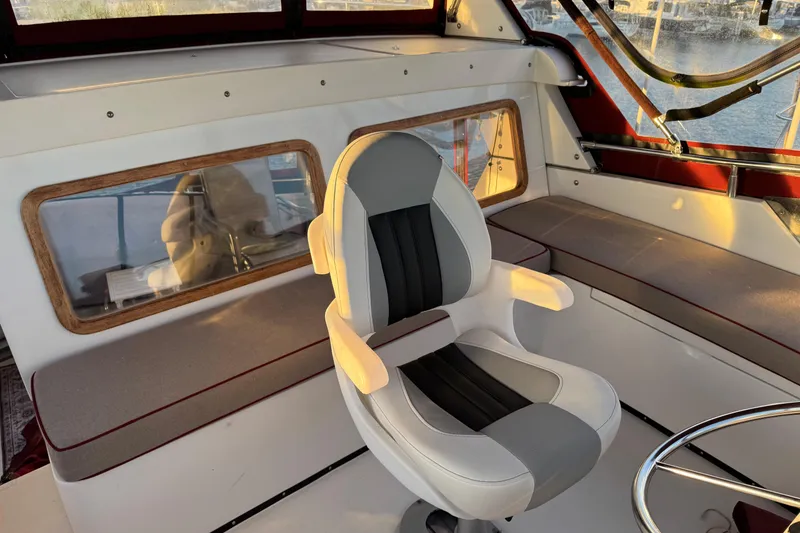 Slide: The Image of Interior of a 1987 President 37 boat with a modern captain's chair and panoramic windows. - 66