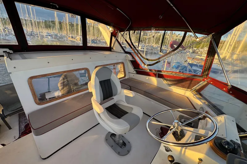 Slide: The Image of Interior of a 1987 President 37 yacht with helm and seating area. - 67