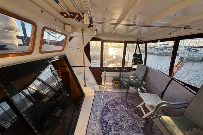 Slide: The Image of Interior of a 1987 President 37 yacht with seating, table, and marina view. - 7