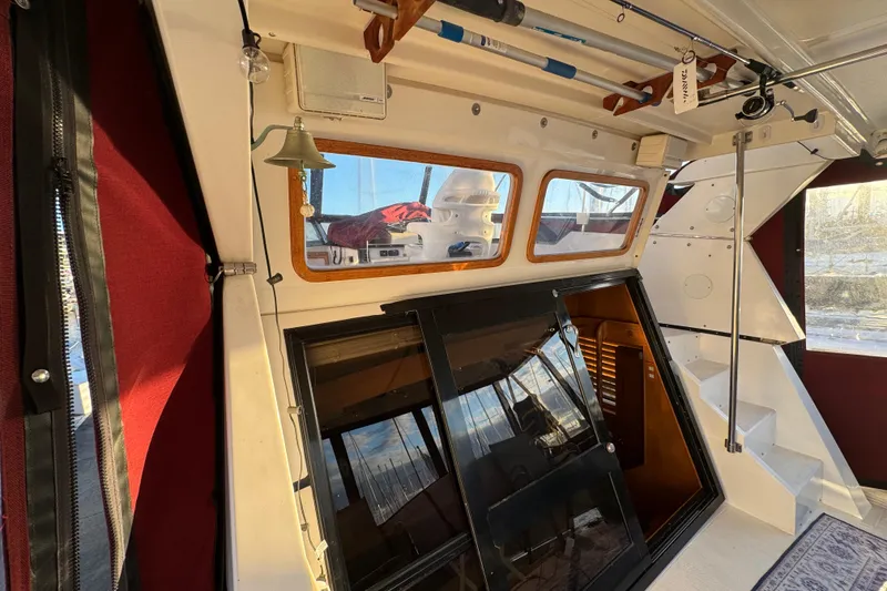 Slide: The Image of Interior of a 1987 President 37 boat with fishing rods and nautical decor. - 8