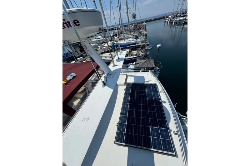 Slide: The Image of 1987 President 37 yacht with solar panels docked at a marina. - 73