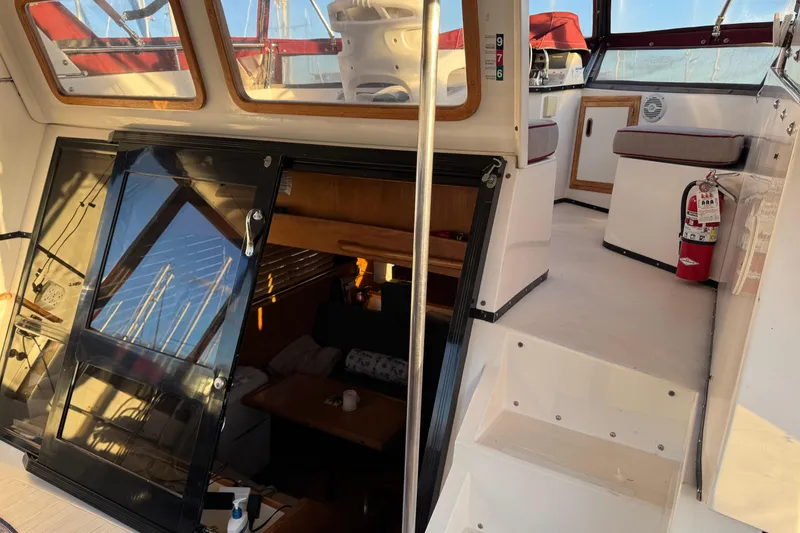 Slide: The Image of Interior view of a 1987 President 37 yacht, featuring stairs and seating area. - 9