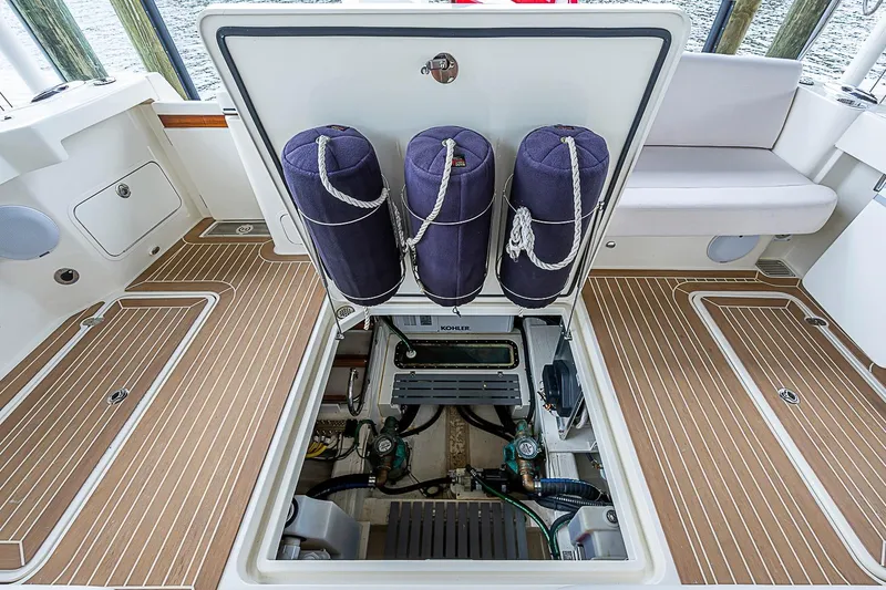Slide: The Image of 2023 Hinckley Sport Boat 40 X engine compartment with open hatch and fenders. - 26