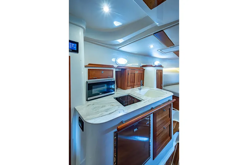 Slide: The Image of Luxurious interior of 2023 Hinckley Sport Boat 40 X with modern kitchen amenities. - 21