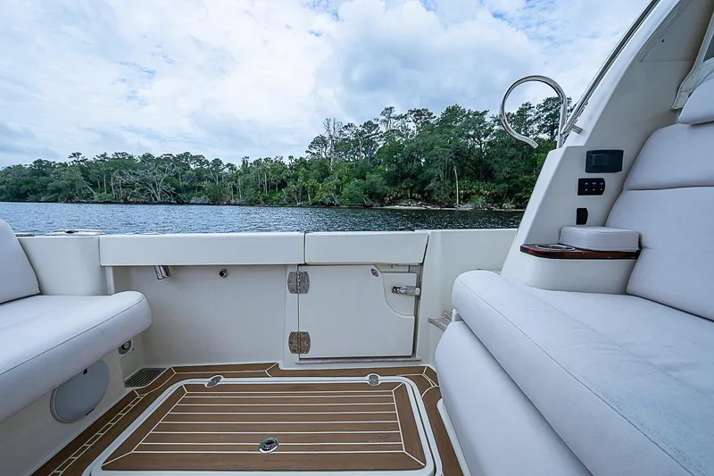 Slide: The Image of 2023 Hinckley Sport Boat 40 X interior with scenic river view. - 8