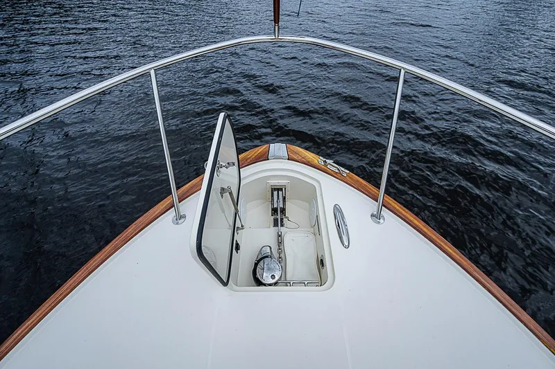 Slide: The Image of Hinckley Sport Boat 40 X 2023 bow view with open anchor hatch on water. - 17