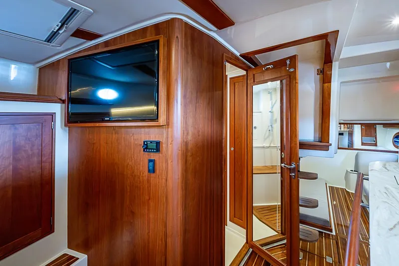 Slide: The Image of Interior of 2023 Hinckley Sport Boat 40 X with wood paneling and modern amenities. - 20