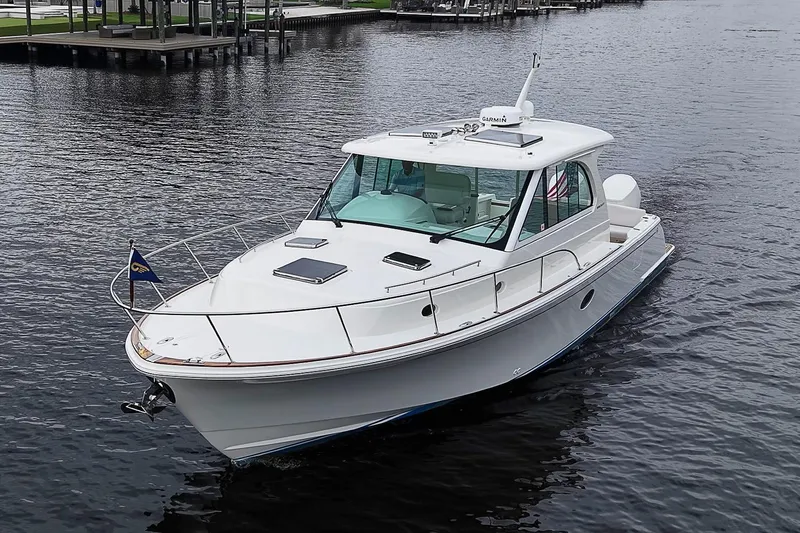 Slide: The Image of 2023 Hinckley Sport Boat 40 X cruising on calm waters. - 2