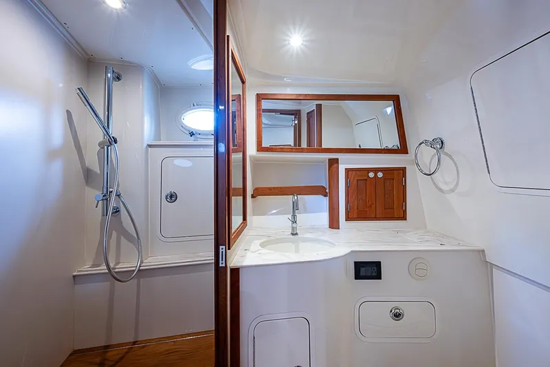 Slide: The Image of Luxurious bathroom interior of 2023 Hinckley Sport Boat 40 X with modern fixtures. - 24