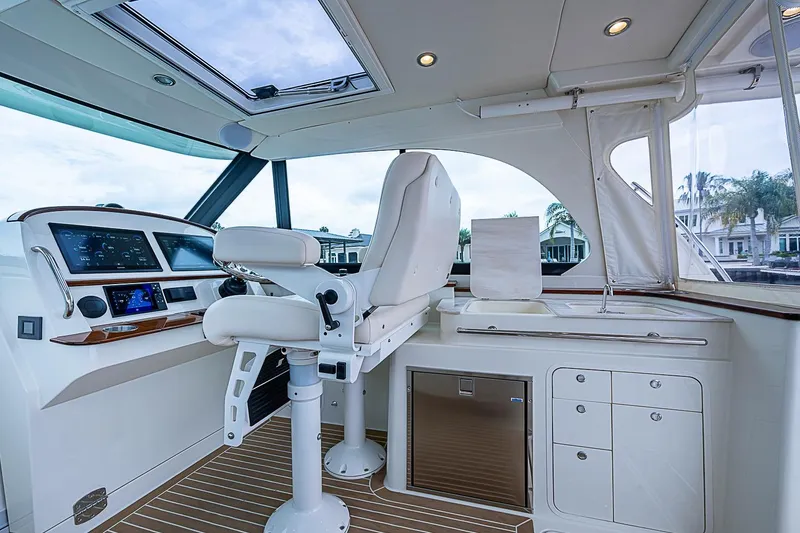 Slide: The Image of Interior of 2023 Hinckley Sport Boat 40 X, featuring helm and seating area. - 15