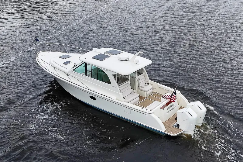 Slide: The Image of 2023 Hinckley Sport Boat 40 X cruising on open water, rear view. - 3
