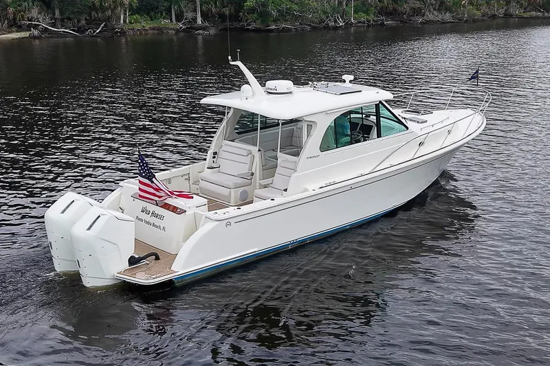 The Image of 2023 Hinckley Sport Boat 40 X cruising on a calm river. - 0