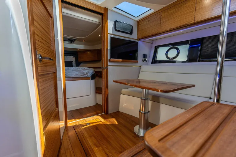 Slide: The Image of Luxurious interior of 2023 Boston Whaler 405 Conquest, featuring wood finishes and modern seating. - 11