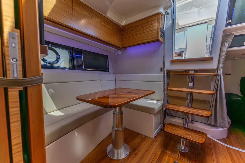 Slide: The Image of Luxurious interior of 2023 Boston Whaler 405 Conquest with wooden accents and modern seating. - 12