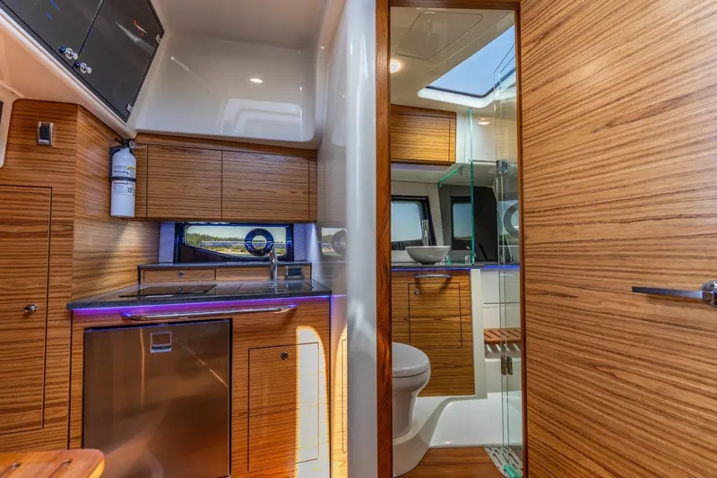 Slide: The Image of Interior of 2023 Boston Whaler 405 Conquest, featuring modern kitchen and bathroom design. - 16