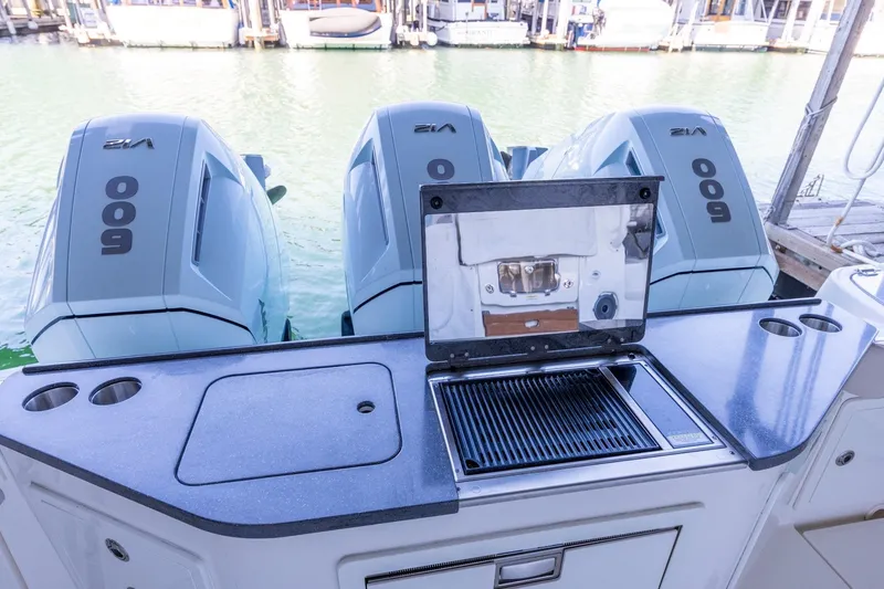 Slide: The Image of 2023 Boston Whaler 405 Conquest with triple 600hp engines and onboard grill. - 19