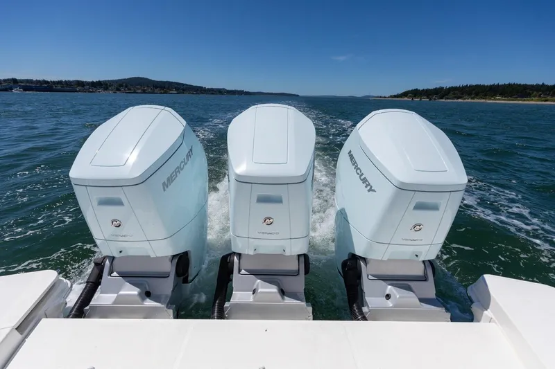 Slide: The Image of 2023 Boston Whaler 405 Conquest with triple Mercury outboard engines on open water. - 22