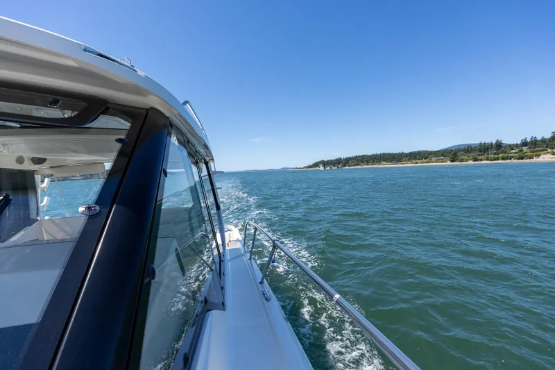 Slide: The Image of Boston Whaler 405 Conquest cruising on open water, clear blue sky, 2023 model. - 25