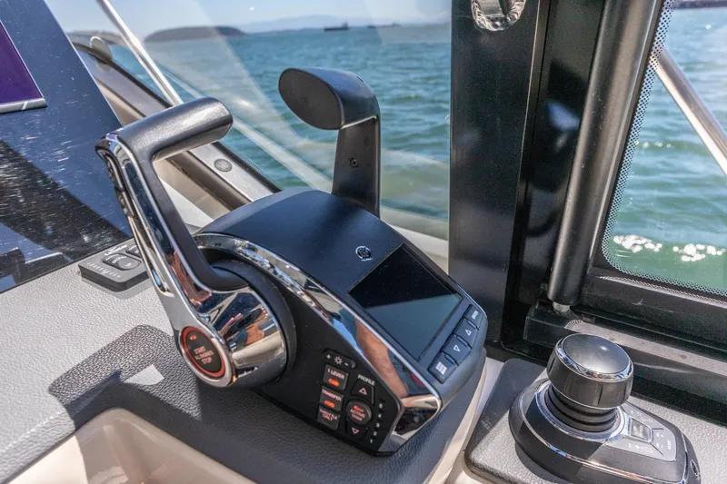 Slide: The Image of Control panel of 2023 Boston Whaler 405 Conquest boat with throttle and joystick. - 30