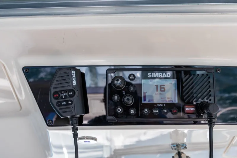 Slide: The Image of Simrad marine radio system on 2023 Boston Whaler 405 Conquest boat dashboard. - 31
