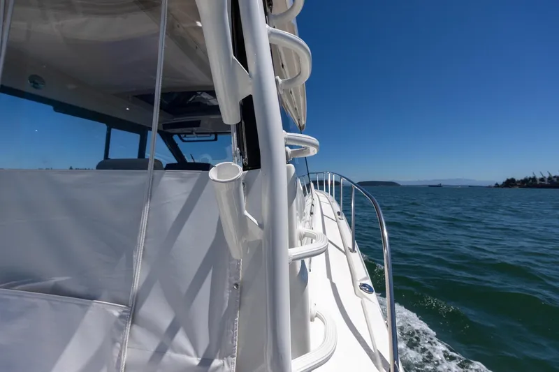 Slide: The Image of 2023 Boston Whaler 405 Conquest cruising on open water under clear blue skies. - 33