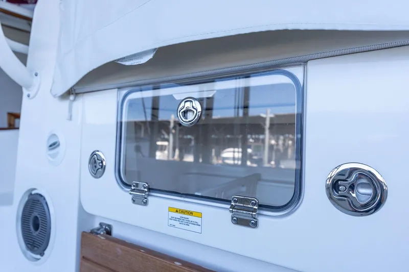 Slide: The Image of 2023 Boston Whaler 405 Conquest boat hatch with chrome fittings and caution label. - 35