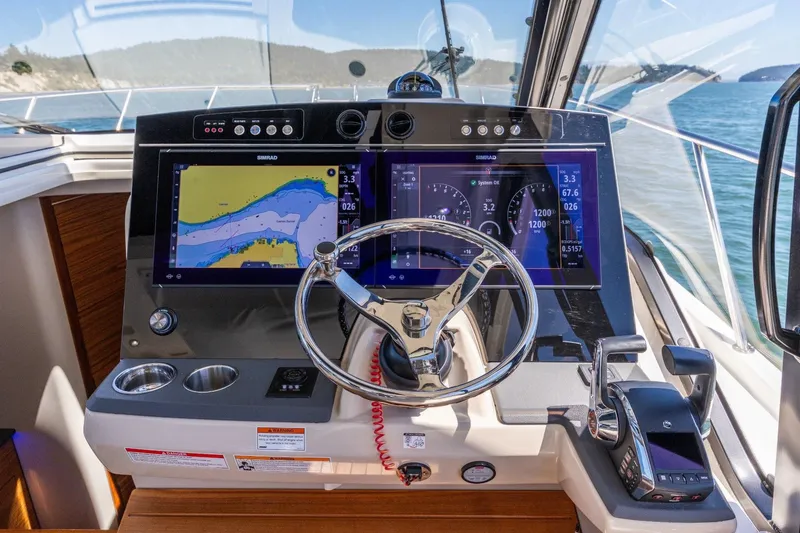 Slide: The Image of 2023 Boston Whaler 405 Conquest helm with advanced navigation displays and controls. - 6