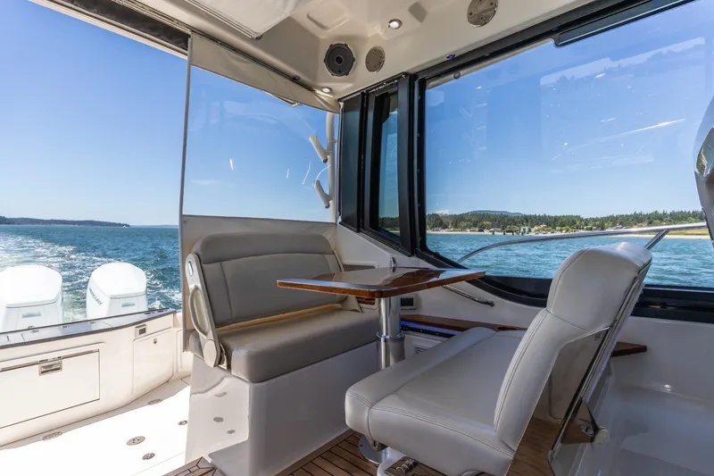Slide: The Image of Interior of 2023 Boston Whaler 405 Conquest boat with seating and ocean view. - 9