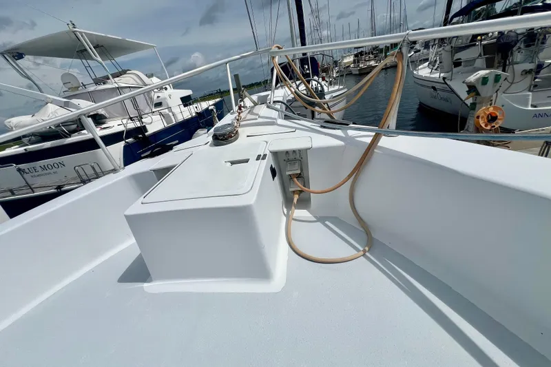 Slide: The Image of 1999 Mainship 350 Trawler docked at marina, showcasing deck and railing. - 12