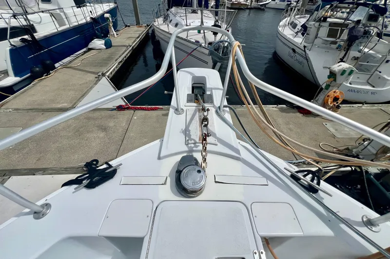 Slide: The Image of 1999 Mainship 350 Trawler docked at marina, showcasing bow and anchor setup. - 13