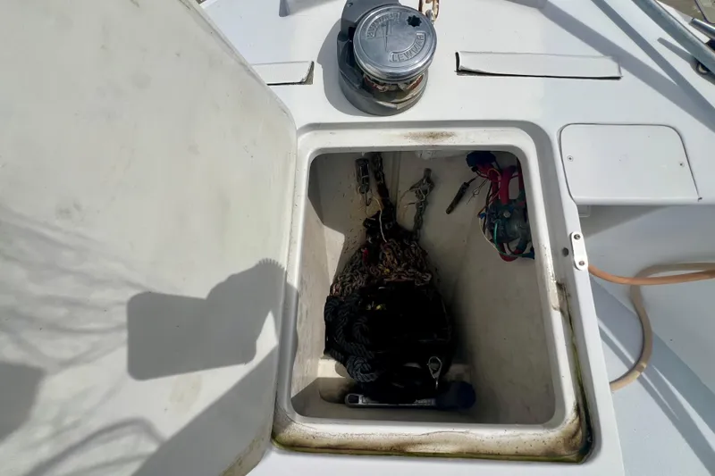 Slide: The Image of Anchor locker of a 1999 Mainship 350 Trawler with chains and ropes visible. - 14
