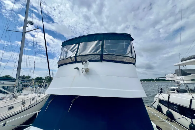 Slide: The Image of 1999 Mainship 350 Trawler docked under a cloudy sky. - 16