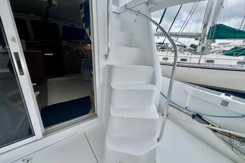 Slide: The Image of Staircase on 1999 Mainship 350 Trawler yacht, leading to upper deck, with marina view. - 17
