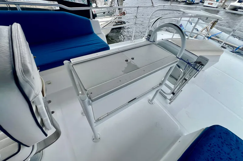 Slide: The Image of 1999 Mainship 350 Trawler deck with seating and storage, docked at marina. - 20