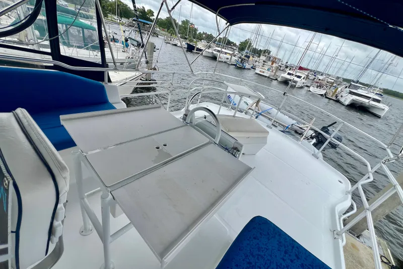 Slide: The Image of 1999 Mainship 350 Trawler deck with seating and table, docked at marina. - 21
