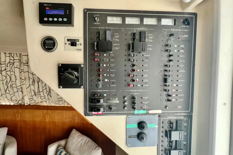 Slide: The Image of Control panel of a 1999 Mainship 350 Trawler, featuring various switches and gauges. - 31
