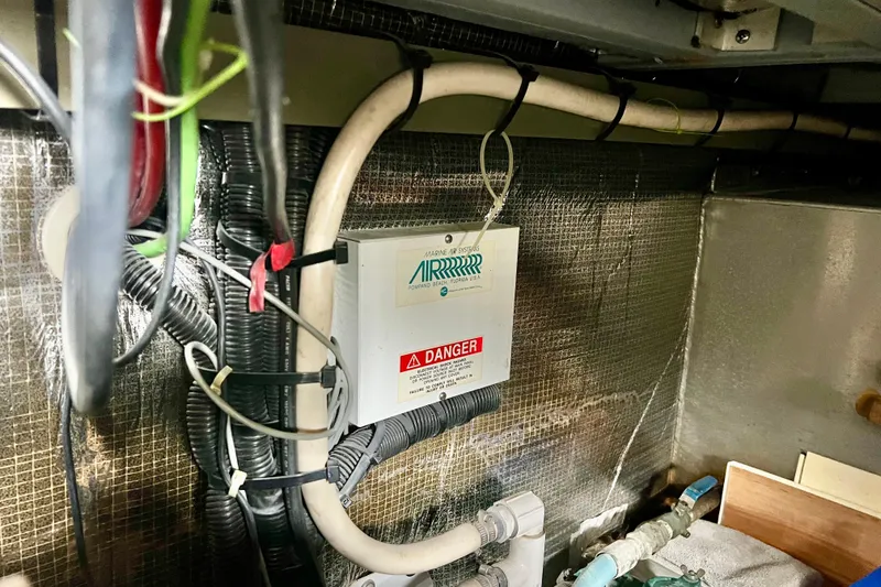 Slide: The Image of Electrical wiring and control box inside a 1999 Mainship 350 Trawler boat. - 45