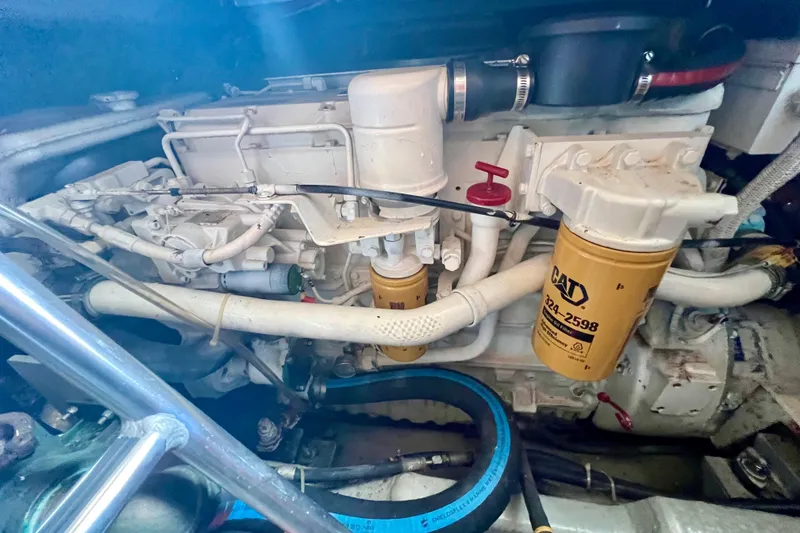 Slide: The Image of Engine compartment of a 1999 Mainship 350 Trawler with visible CAT filters. - 47