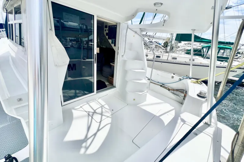 Slide: The Image of 1999 Mainship 350 Trawler deck with stairs and sliding door, docked at marina. - 5