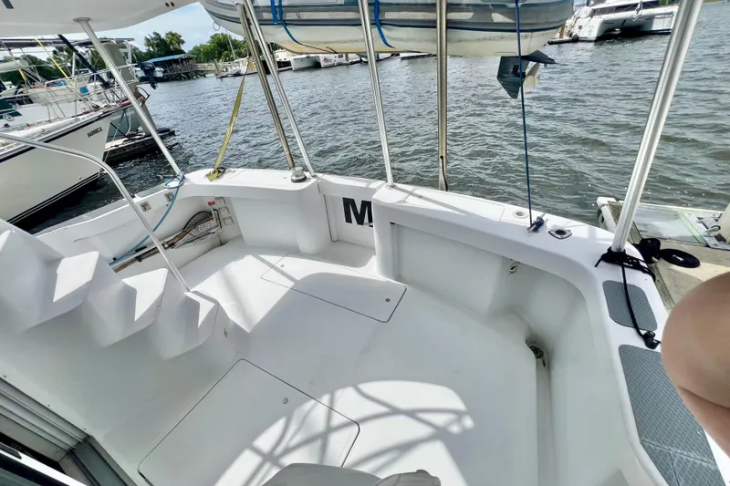 Slide: The Image of 1999 Mainship 350 Trawler's deck with marina view, featuring steps and railing. - 6