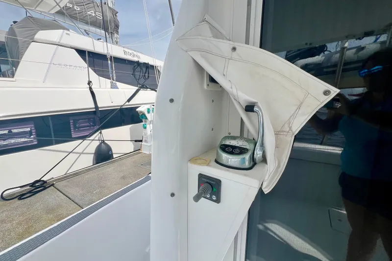 Slide: The Image of 1999 Mainship 350 Trawler control panel with throttle lever, docked beside another boat. - 7