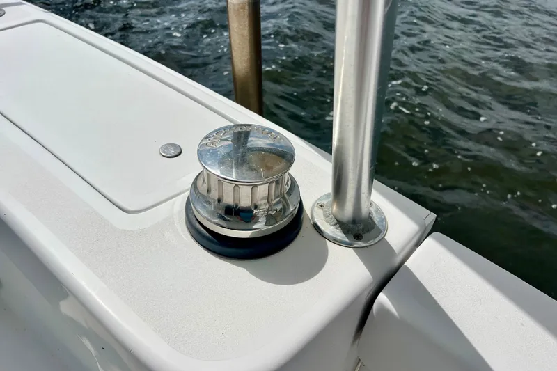 Slide: The Image of Chrome winch on 1999 Mainship 350 Trawler deck by water. - 9