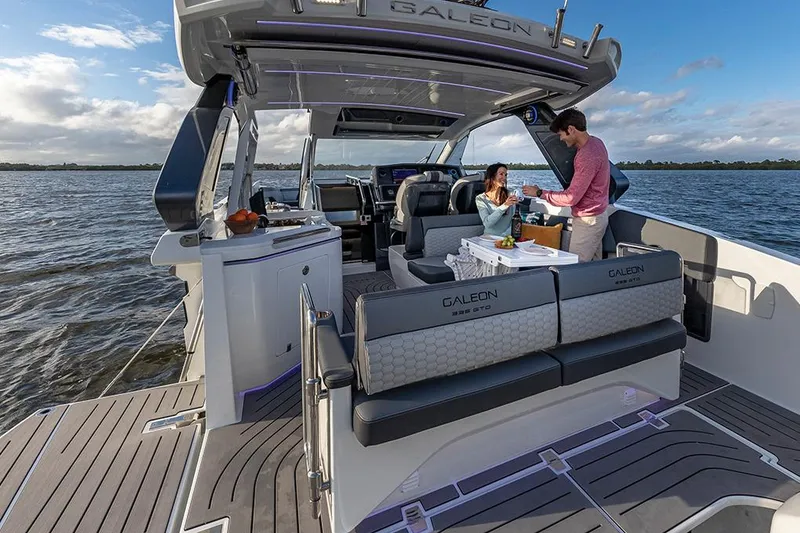Slide: The Image of Manufacturer Provided Image: 2025 Galeon 335 GTO yacht with people enjoying a meal on deck, scenic water view. - 3