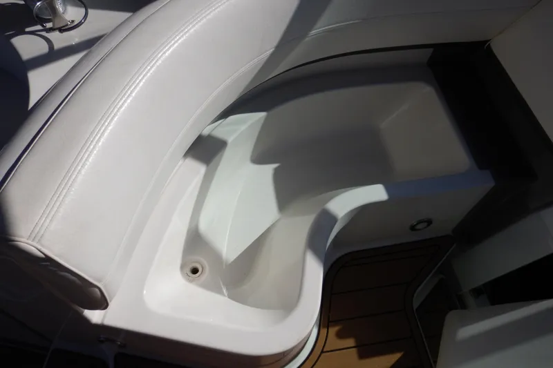 Slide: The Image of 2007 Cruisers 340 Express boat interior seating with white upholstery and wooden flooring. - 15