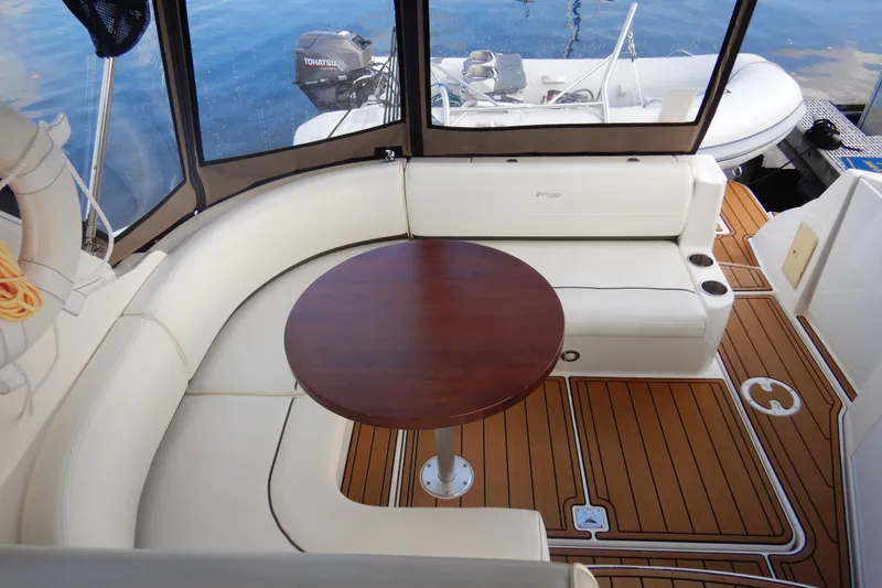 Slide: The Image of 2007 Cruisers 340 Express yacht interior with seating and wooden table on deck. - 17