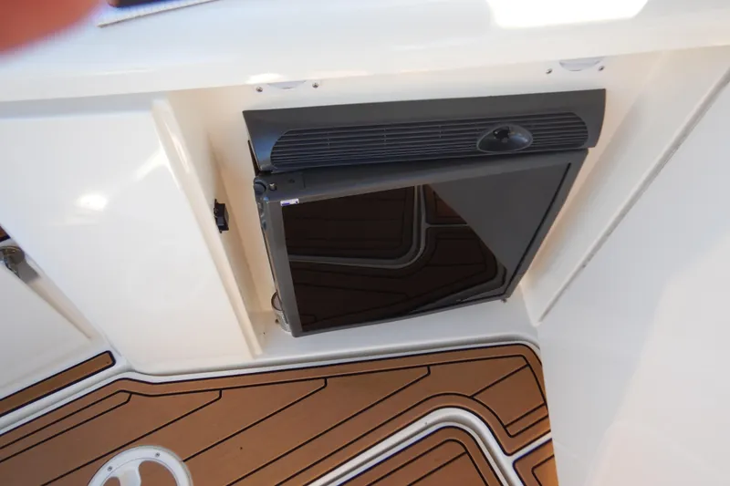 Slide: The Image of 2007 Cruisers 340 Express boat interior with a built-in refrigerator and teak flooring. - 19