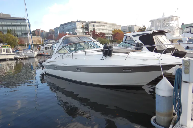 Slide: The Image of 2007 Cruisers 340 Express yacht docked in a marina, surrounded by other boats. - 2